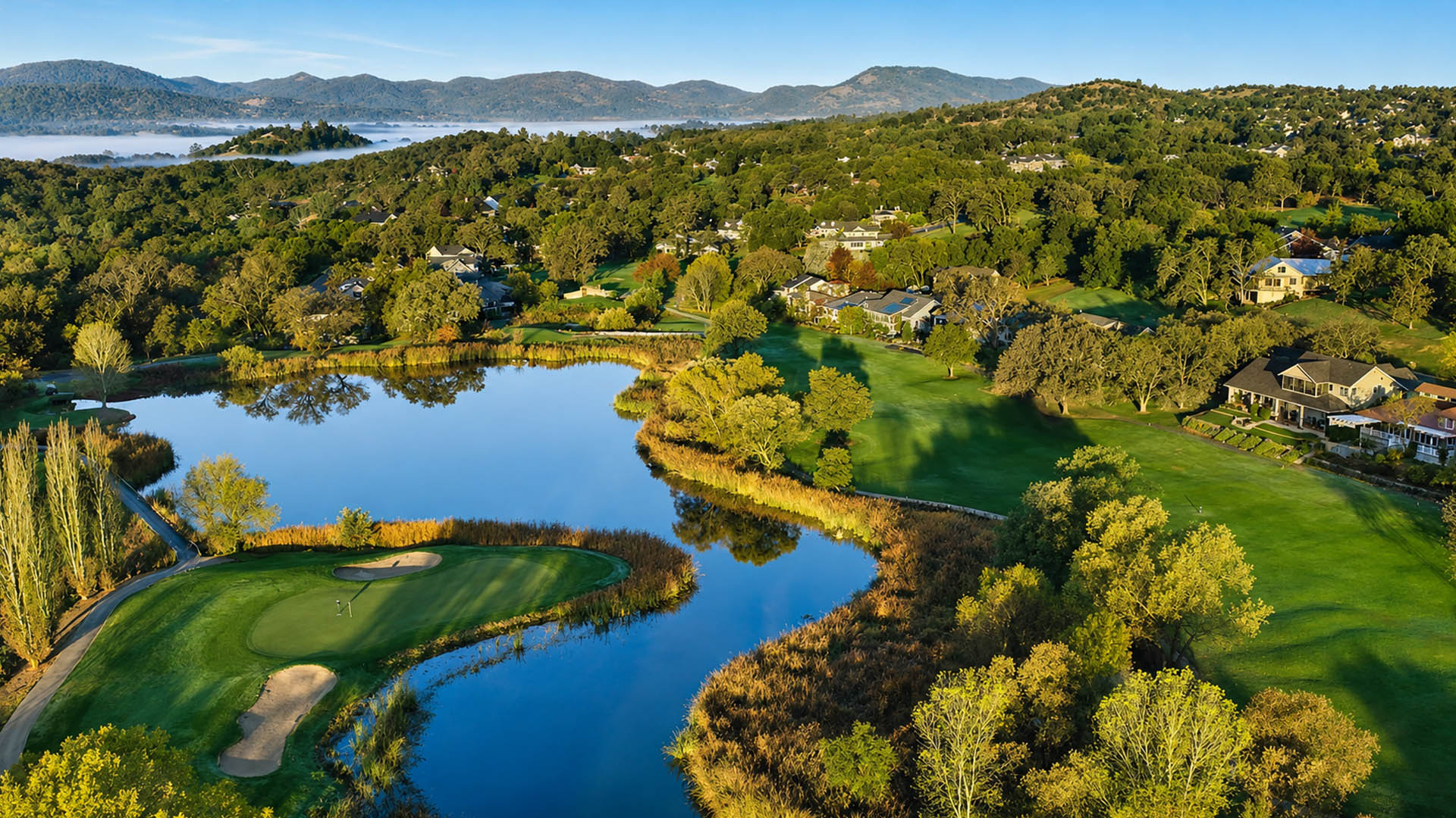 Aerial view of Greenhorn Creek Golf course surrounded by mountains.